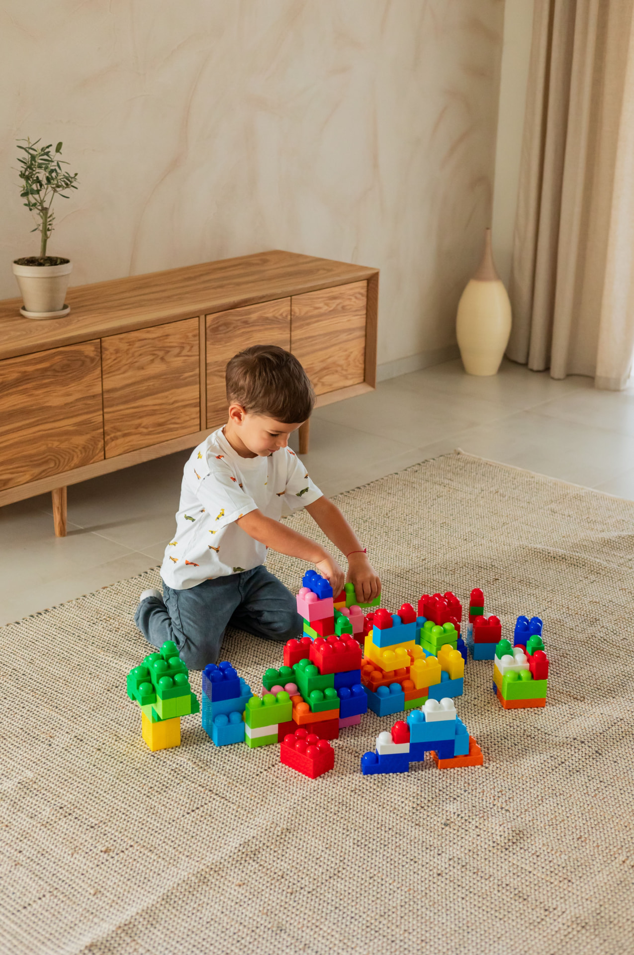 Child playing with colorful building blocks during a parenting class activity